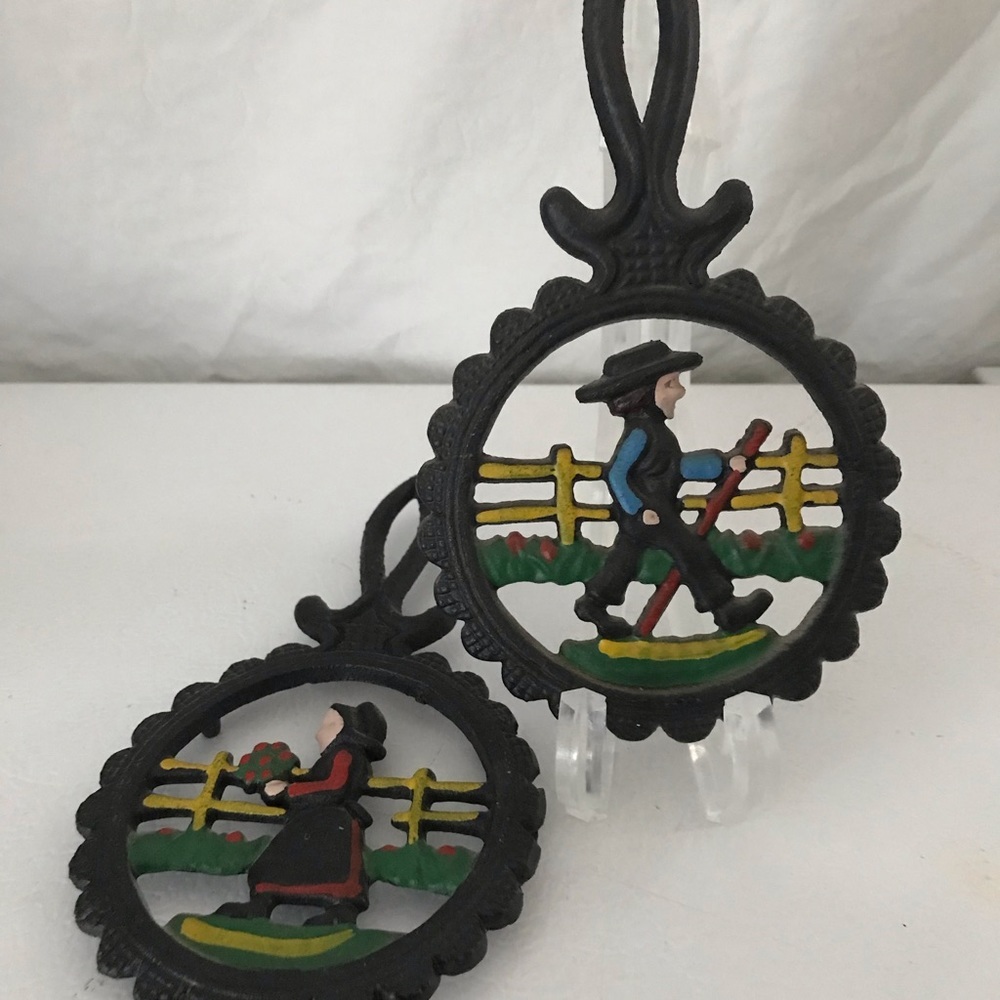 Unbranded Set/2 Amish Cast Iron Trivets Folk Art Painted Dutch Farmers Colored